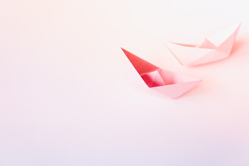 pastel color paper boat on clean background with copy space, learning and education concept