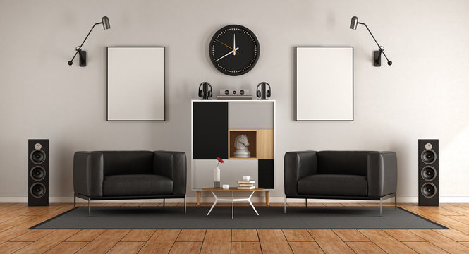 living room with two black armchairs and audio equipment