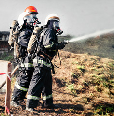 Firefighters training, foreground is drop of water springer