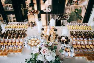  Beautifully decorated wedding dessert table with cakes and echleurs and other sweets