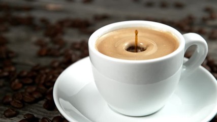 Drop falling into a cup of coffee in super slowmotion.