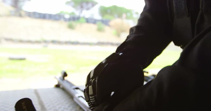 Mid section of military soldier wearing military gloves during military training 4k