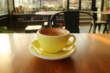 Having quiet time with a cup of cappuccino coffee in an empty cafe