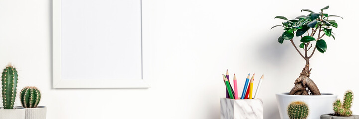 Desk at the white empty wall. Panoramic copy space. Place for text. Scandinavian style. White empty...