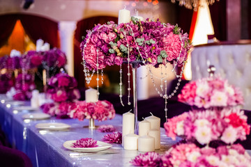 Wedding party table flowers on the table. Pink pions and wite chrysanthemums