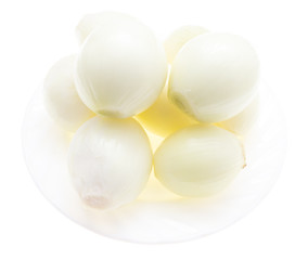 Peeled onions in a plate on a white background