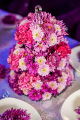 Wedding party table flowers on the table. Pink pions and wite chrysanthemums