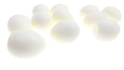Peeled boiled eggs on a white background