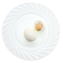 Peeled boiled eggs in a plate on a white background