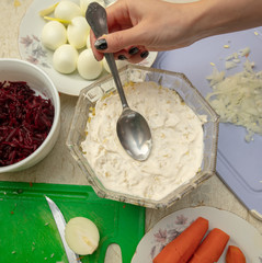 Cooking herring under a fur coat in the kitchen