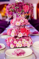 Wedding party table flowers on the table. Pink pions and wite chrysanthemums