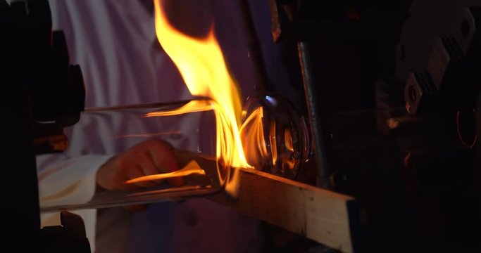 Mid section of male worker creating glass in glass factory 4k