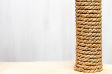 sisal rope cat scratching post on white background, copy space for text