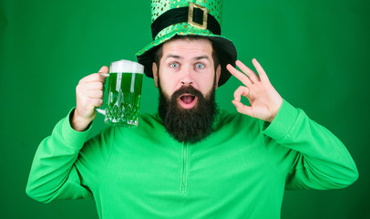 Dyed green traditional beer. Patricks day party. Alcohol beverage. Symbol of Ireland. Man bearded hipster drink beer. Irish pub. Highly recommend. Drinking beer celebration. Fest and holiday menu