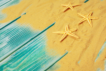 Fototapeta na wymiar Sea sand and Sea shells on blue wooden floor