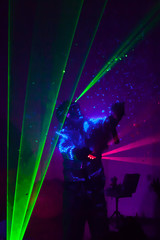 Naklejka na ściany i meble Colorful lights show. Laser show in motion in dark