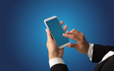 Mockup for female hand using frameless smartphone with dark background
