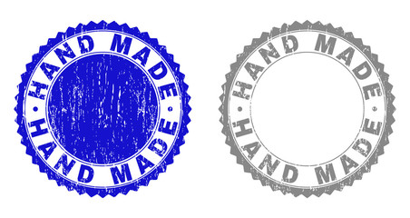 Grunge HAND MADE stamp seals isolated on a white background. Rosette seals with distress texture in blue and gray colors. Vector rubber stamp imprint of HAND MADE label inside round rosette.