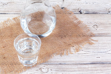 Glasses of water on a wooden table.