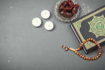 Fototapeta na wymiar Table top decoration Ramadan Kareem holiday background of dates with rosary & The holy book of Koran