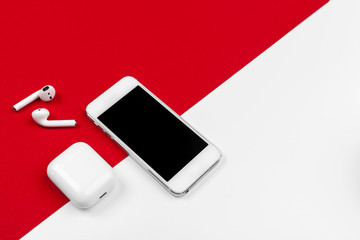 Obraz premium Mock up with copy space with smartphone on bright red background