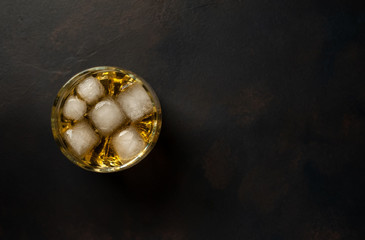 Whiskey with ice on concrete