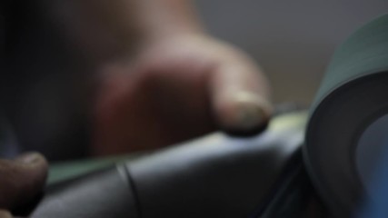 the shoe is sanded with the grinder before the sole is glued and attaches to the shoe shape in workshop by handmade artisan manufacturing leather shoe, manufacture traditional shoemaker craftsman