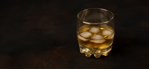 Whiskey with ice on concrete