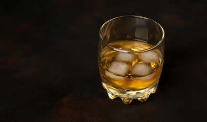Whiskey with ice on concrete