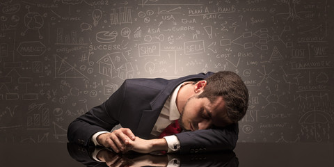 Elegant teacher fell asleep at his workplace with full draw blackboard concept
