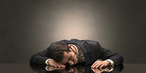 Young businessman fell asleep at his workplace with copy space