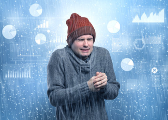Young businessman shivering with graphs, reports and chart concept
