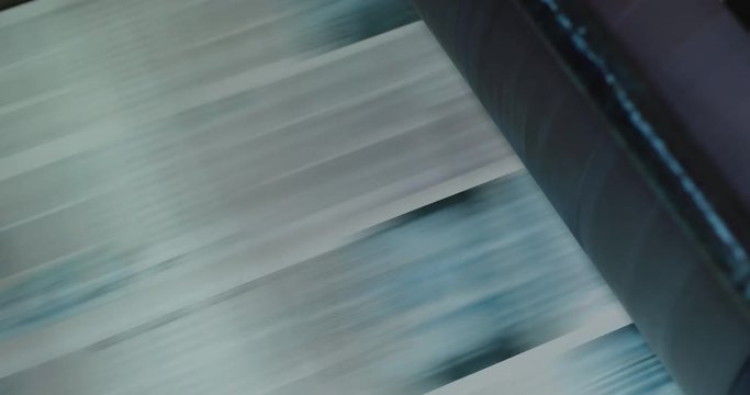 Print plant factory. Newspaper printing at a plant. Newspaper printed on a printing house machine. Close up