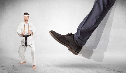 Big foot trample young karate trainer concept
