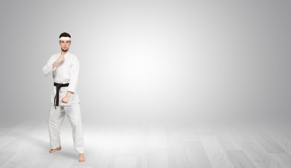 Young kung-fu trainer fighting in an empty space
