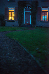 Illuminated window of house in twilight.