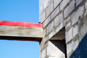 close-up view of the docking concrete beam with a wooden log to the foam block wall of a country...