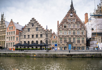 Naklejka premium Historic buildings next to the river in the Ghent city center, Belgium