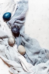 Dyed Easter vintage eggs with scuffs on a light gray background. Stylish Background with easter...