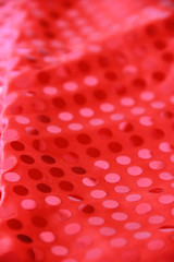 festive red synthetic fabric with round shiny sequins