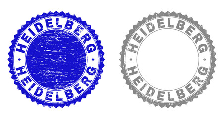 Grunge HEIDELBERG stamp seals isolated on a white background. Rosette seals with distress texture in blue and grey colors. Vector rubber stamp imitation of HEIDELBERG title inside round rosette.
