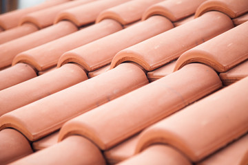 Tiled roof. Background of beautiful modern orange tile. Close up.