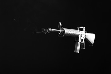 Assault rifle on dark background