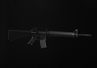 Assault rifle on dark background