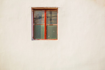 Red old steel fram window on old wall on a bright day, empty space for copy