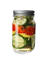 Glass jar with fermented vegetables on white background