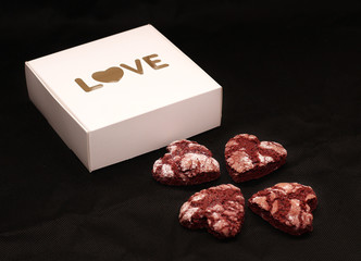 red chocolate cracked heart-shaped cookies with a white box. A gift for Valentine's Day, World Women's Day or Birthday