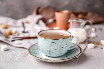 Cup of hot coffee on table