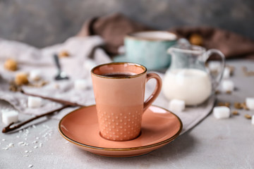 Cup of hot coffee on table