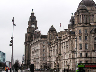 Empty street in Liverpool during a cloudy day with a grey sky and rain drops on the ground